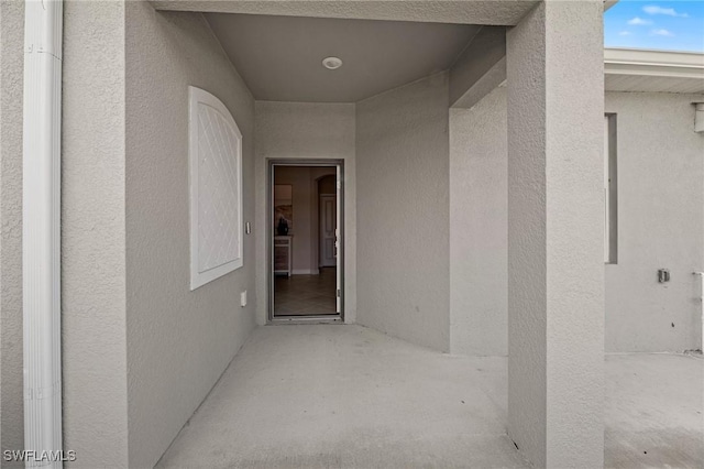 9051 Leatherwood Loop, Lehigh Acres, FL 33936 - doorway to property with stucco siding