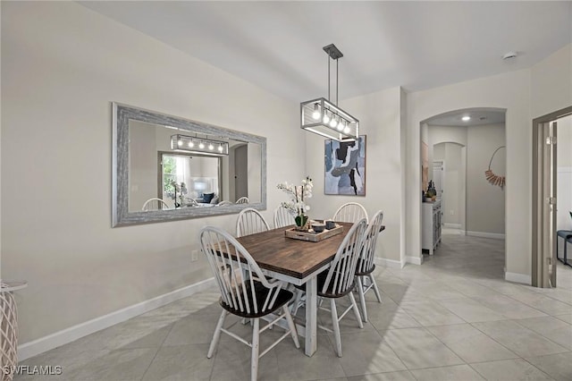 9051 Leatherwood Loop, Lehigh Acres, FL 33936 - dining area with arched walkways and light tile patterned flooring