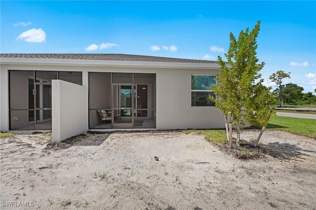 9051 Leatherwood Loop, Lehigh Acres, FL 33936 - back of house with a sunroom and stucco siding