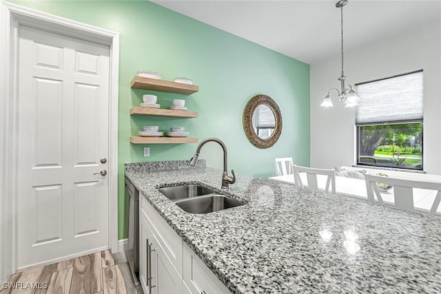 3980 Full Moon Ct, Naples, FL 34112 - kitchen featuring white cabinets, hanging light fixtures, stainless steel dishwasher, open shelves, and light stone counters