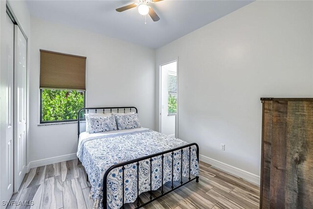 3980 Full Moon Ct, Naples, FL 34112 - bedroom with wood finished floors, a ceiling fan, and a closet