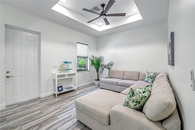3980 Full Moon Ct, Naples, FL 34112 - living area featuring a ceiling fan, a tray ceiling, a skylight, light wood-type flooring, and recessed lighting