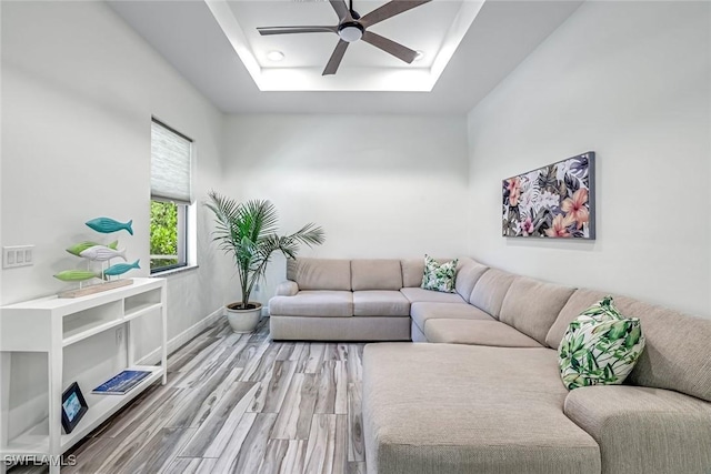 3980 Full Moon Ct, Naples, FL 34112 - living room with a ceiling fan, a tray ceiling, and wood finished floors