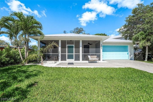 3980 Full Moon Ct, Naples, FL 34112 - back of house featuring driveway, a yard, an attached garage, and ceiling fan