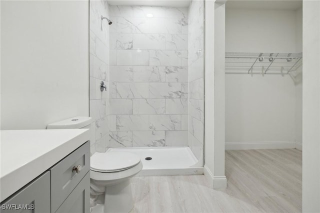1836 Jacinto Ave, Lehigh Acres, FL 33972 - bathroom featuring vanity, tiled shower, wood finished floors, and a walk in closet