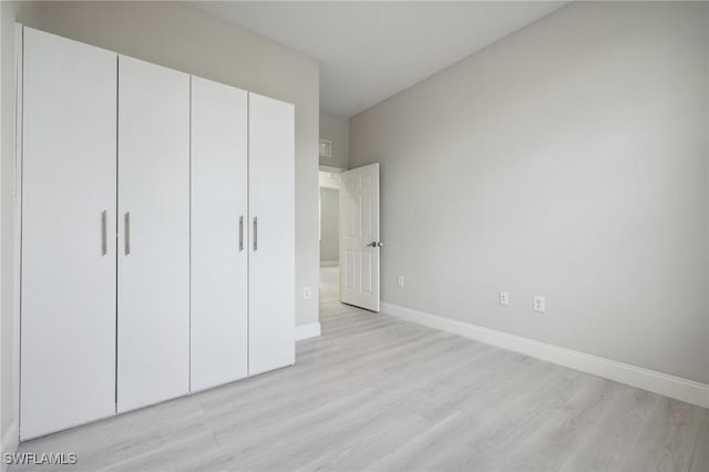 1836 Jacinto Ave, Lehigh Acres, FL 33972 - unfurnished bedroom featuring light wood finished floors and a closet