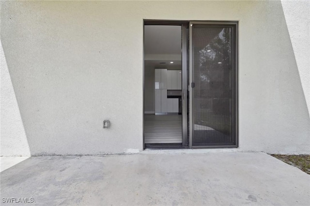1836 Jacinto Ave, Lehigh Acres, FL 33972 - view of exterior entry featuring stucco siding and a patio area