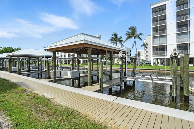 4265 Bay Beach Ln Unit 226, Fort Myers Beach, FL 33931 - dock with boat lift and a water view