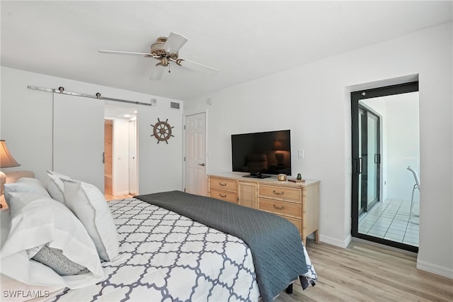 4265 Bay Beach Ln Unit 226, Fort Myers Beach, FL 33931 - bedroom featuring light wood-type flooring, a barn door, and ceiling fan