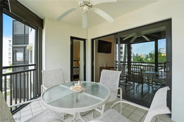 4265 Bay Beach Ln Unit 226, Fort Myers Beach, FL 33931 - balcony with ceiling fan and outdoor dining area