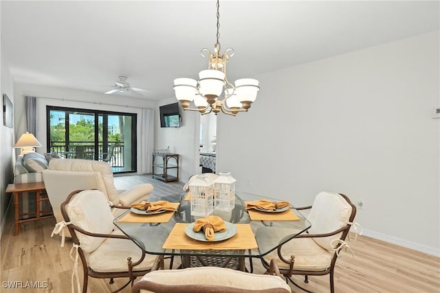 4265 Bay Beach Ln Unit 226, Fort Myers Beach, FL 33931 - dining area with a chandelier, light wood-style flooring, and a ceiling fan