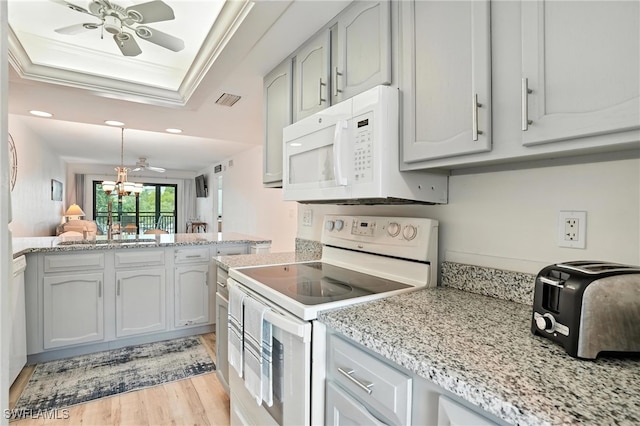 4265 Bay Beach Ln Unit 226, Fort Myers Beach, FL 33931 - kitchen featuring white appliances, a ceiling fan, a raised ceiling, light wood-type flooring, and recessed lighting