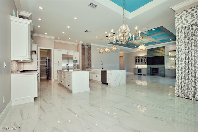 3309 SW 2nd Ln, Cape Coral, FL 33991 - kitchen with an island with sink, crown molding, open floor plan, recessed lighting, and a chandelier