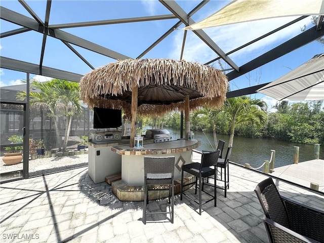 17921 Stevens Blvd, Fort Myers Beach, FL 33931 - view of patio / terrace with exterior kitchen, a lanai, and a boat dock