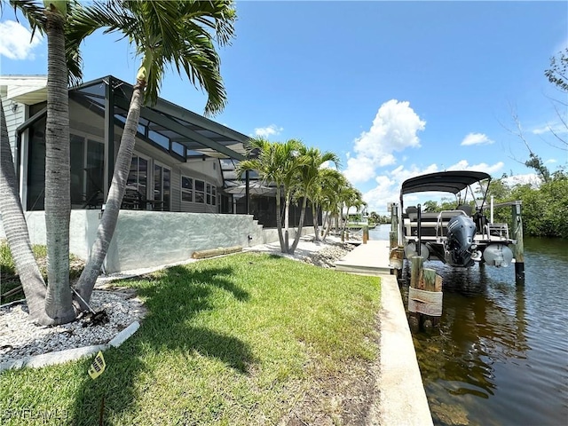 17921 Stevens Blvd, Fort Myers Beach, FL 33931 - dock with boat lift, a water view, a yard, and a lanai