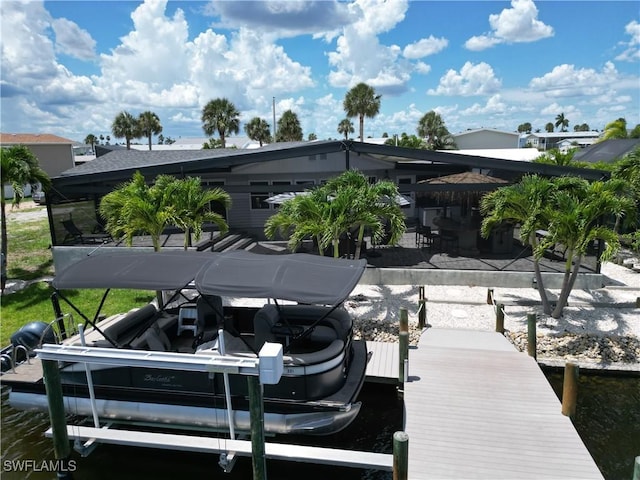 17921 Stevens Blvd, Fort Myers Beach, FL 33931 - dock featuring boat lift and a patio