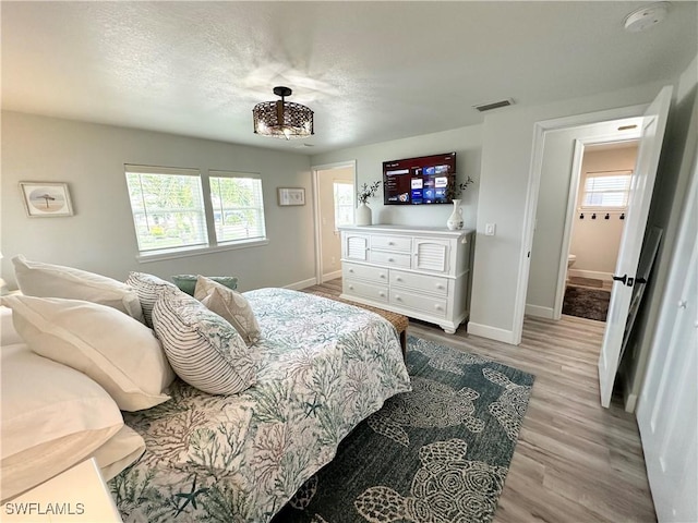 17921 Stevens Blvd, Fort Myers Beach, FL 33931 - bedroom with wood finished floors and a textured ceiling