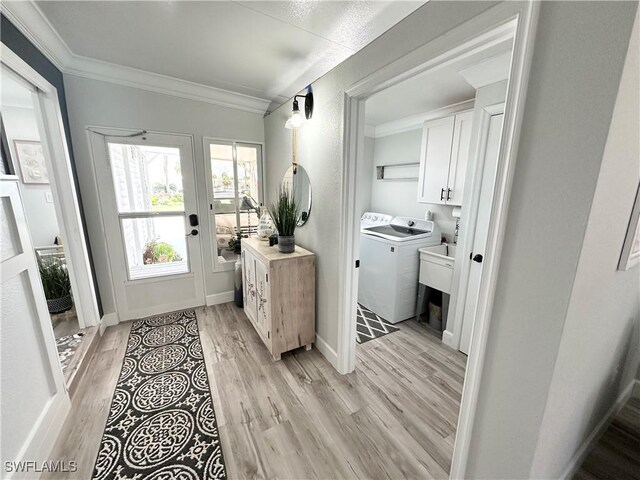 17921 Stevens Blvd, Fort Myers Beach, FL 33931 - foyer entrance featuring washer / clothes dryer, ornamental molding, and light wood-type flooring