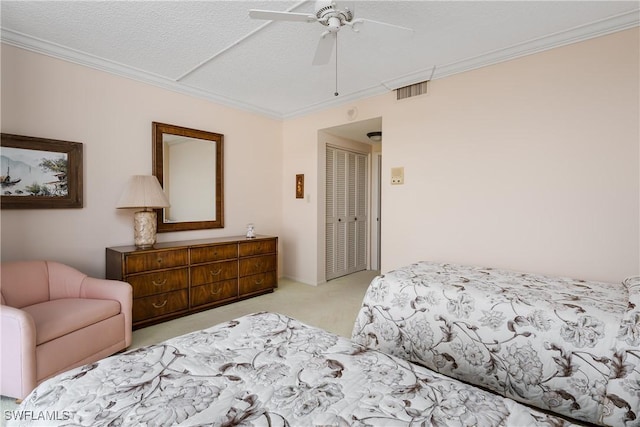 174 S Collier Blvd Unit 904, Marco Island, FL 34145 - carpeted bedroom with ornamental molding, a closet, a textured ceiling, and ceiling fan