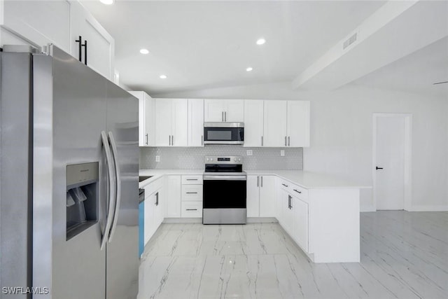 2118 Aldridge Ave, Fort Myers, FL 33907 - kitchen with stainless steel appliances, a peninsula, light marble finish flooring, light countertops, and backsplash