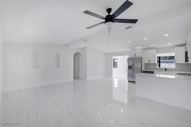 2118 Aldridge Ave, Fort Myers, FL 33907 - unfurnished living room featuring arched walkways, recessed lighting, ceiling fan, and light marble finish flooring