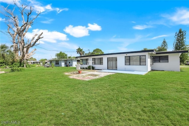 2118 Aldridge Ave, Fort Myers, FL 33907 - back of property featuring stucco siding, a yard, and a patio