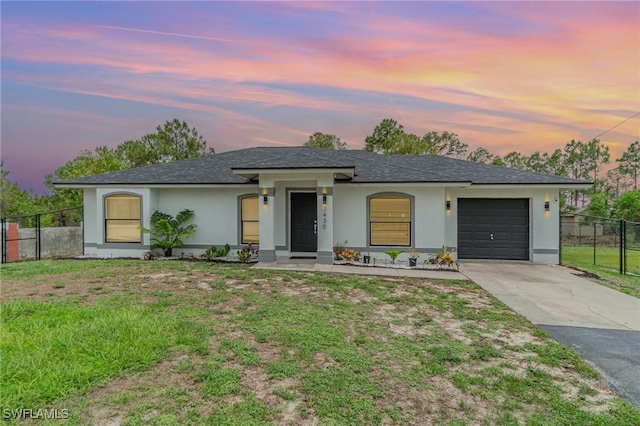 3430 35th Ave NE, Naples, FL 34120 - view of front of home featuring driveway, stucco siding, an attached garage, and roof with shingles