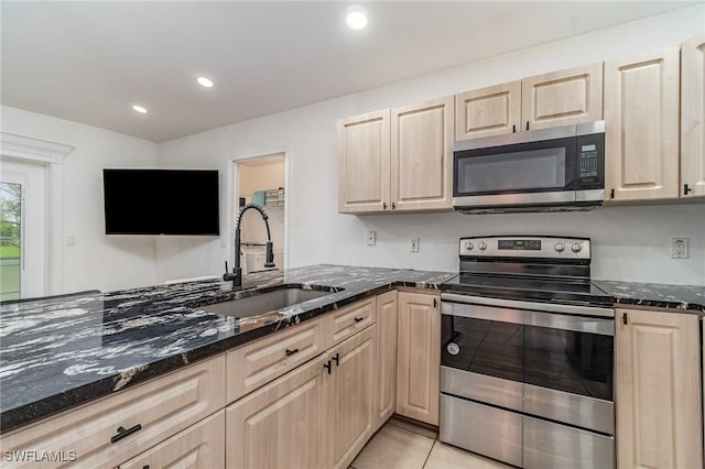 3430 35th Ave NE, Naples, FL 34120 - kitchen featuring stainless steel appliances, light brown cabinetry, dark stone counters, recessed lighting, and light tile patterned flooring