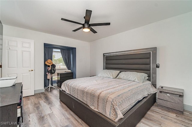 3430 35th Ave NE, Naples, FL 34120 - bedroom with wood finished floors and a ceiling fan