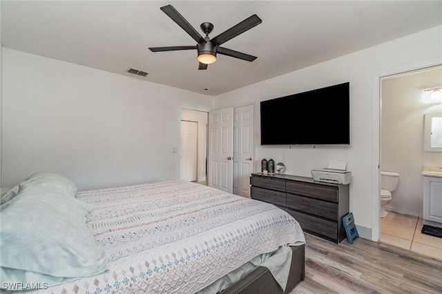 3430 35th Ave NE, Naples, FL 34120 - bedroom featuring light wood-style floors, connected bathroom, and a ceiling fan