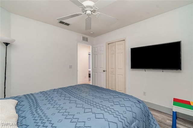 3430 35th Ave NE, Naples, FL 34120 - bedroom featuring wood finished floors, ceiling fan, and a closet