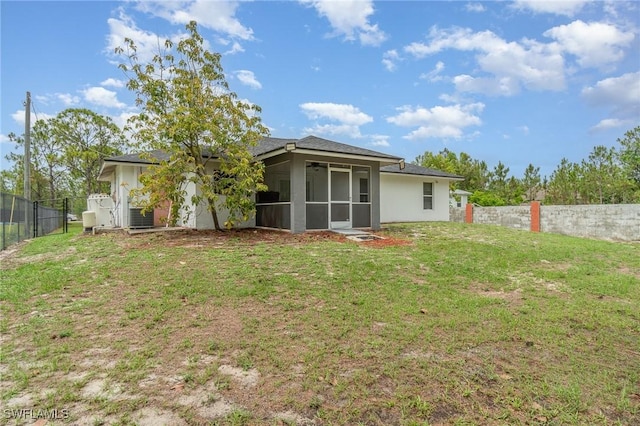 3430 35th Ave NE, Naples, FL 34120 - back of house featuring a sunroom, a fenced backyard, and stucco siding