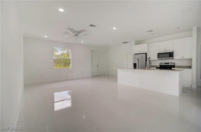 2109 Jefferson Ave, Alva, FL 33920 - kitchen featuring stainless steel appliances, recessed lighting, white cabinetry, a center island with sink, and a ceiling fan