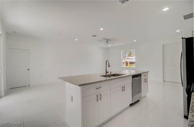 2109 Jefferson Ave, Alva, FL 33920 - kitchen featuring stainless steel appliances, light stone countertops, white cabinets, ceiling fan, and a kitchen island with sink