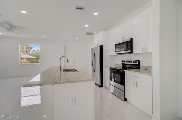 2109 Jefferson Ave, Alva, FL 33920 - kitchen with stainless steel appliances, white cabinetry, ceiling fan, a center island with sink, and recessed lighting
