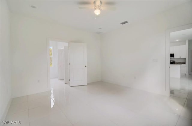 2109 Jefferson Ave, Alva, FL 33920 - empty room with ceiling fan and light tile patterned flooring