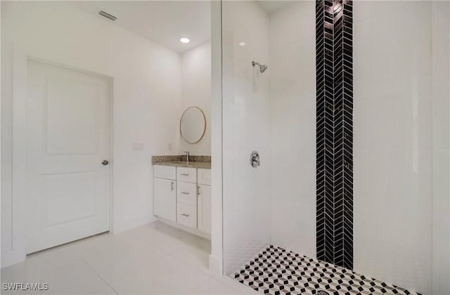 2109 Jefferson Ave, Alva, FL 33920 - bathroom featuring tiled shower, vanity, and tile patterned flooring