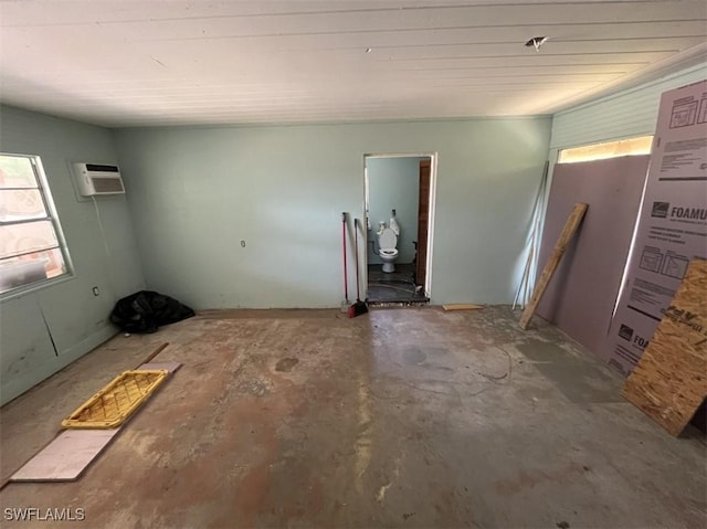 1262 Joerin Ave, North Fort Myers, FL 33903 - empty room with a wall mounted air conditioner and unfinished concrete floors