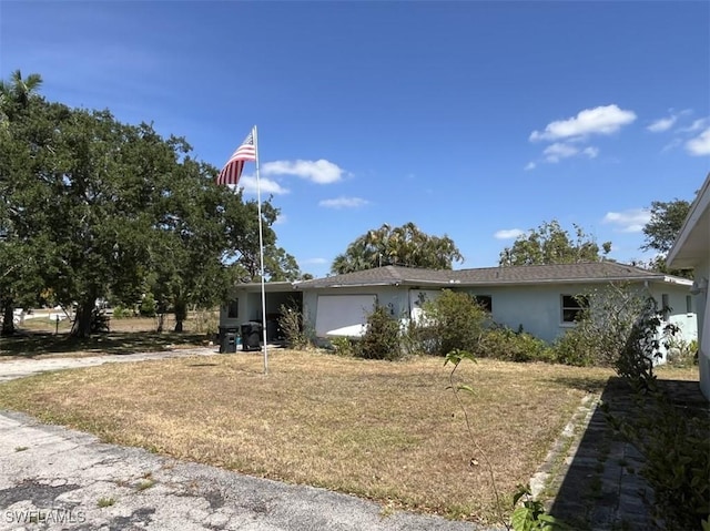 1262 Joerin Ave, North Fort Myers, FL 33903 - view of front of home featuring a garage and stucco siding