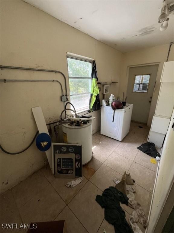 1262 Joerin Ave, North Fort Myers, FL 33903 - laundry area with washer / dryer, light tile patterned floors, and water heater