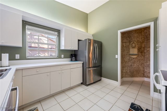 15041 Lakeside View Dr Unit 2104, Fort Myers, FL 33919 - kitchen with appliances with stainless steel finishes, light countertops, white cabinetry, and light tile patterned floors