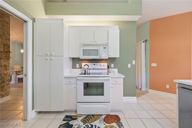 15041 Lakeside View Dr Unit 2104, Fort Myers, FL 33919 - kitchen featuring white appliances, light countertops, light tile patterned flooring, and white cabinetry