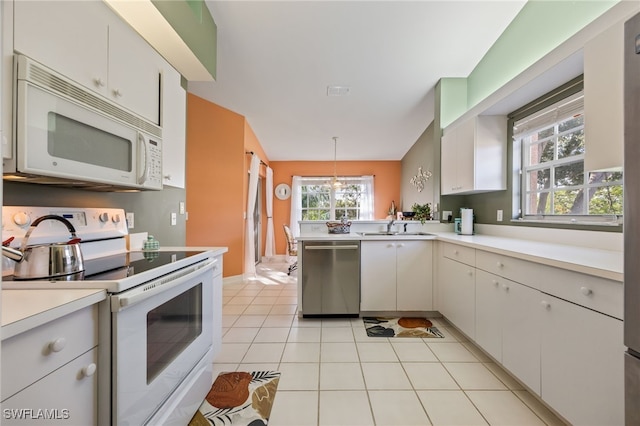 15041 Lakeside View Dr Unit 2104, Fort Myers, FL 33919 - kitchen featuring white appliances, light countertops, a peninsula, and plenty of natural light