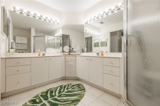 15041 Lakeside View Dr Unit 2104, Fort Myers, FL 33919 - bathroom with tile patterned floors, double vanity, and a shower stall