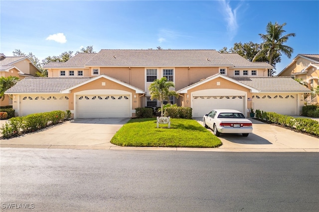 15041 Lakeside View Dr Unit 2104, Fort Myers, FL 33919 - view of front of home featuring concrete driveway, a tile roof, and stucco siding