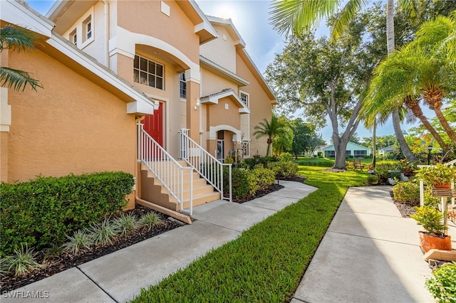 15041 Lakeside View Dr Unit 2104, Fort Myers, FL 33919 - view of front of home featuring stucco siding and a front lawn