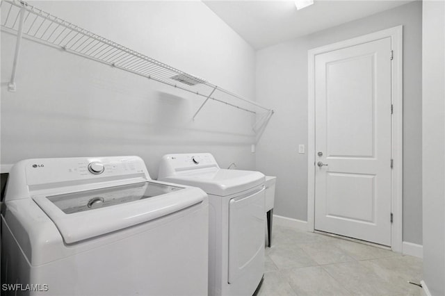 17215 Hadlow Pl, Fort Myers, FL 33967 - laundry room with washer and dryer and light tile patterned floors