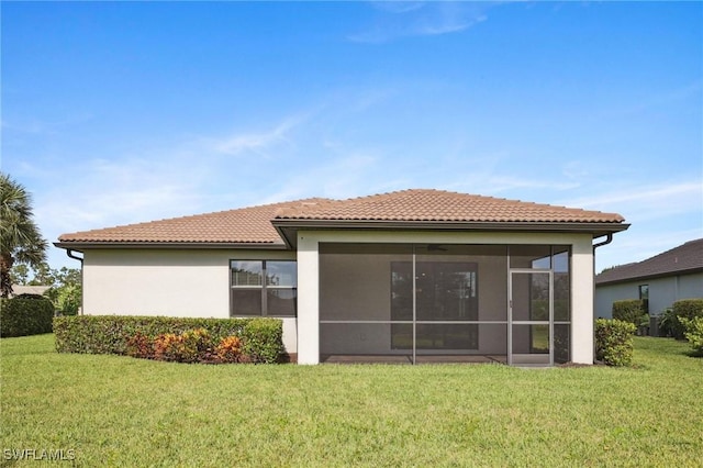 17215 Hadlow Pl, Fort Myers, FL 33967 - rear view of property with a yard, stucco siding, a tiled roof, and a sunroom