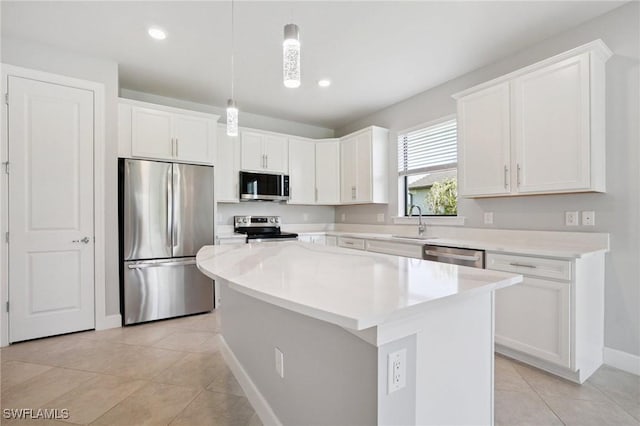 17215 Hadlow Pl, Fort Myers, FL 33967 - kitchen with stainless steel appliances, a center island, white cabinetry, light tile patterned flooring, and hanging light fixtures