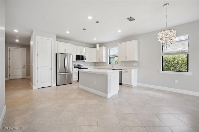17215 Hadlow Pl, Fort Myers, FL 33967 - kitchen featuring appliances with stainless steel finishes, a chandelier, light countertops, recessed lighting, and a kitchen island